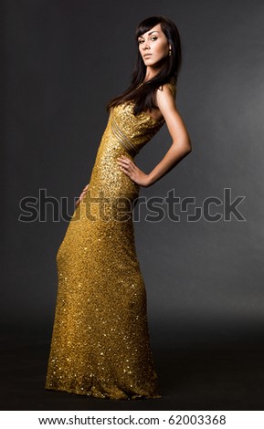 beautiful fashionable woman in golden dress