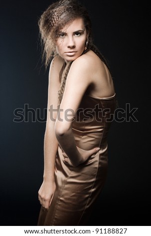 Elegant fashionable woman in golden dress