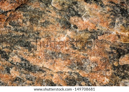 Detailed close up of the surface of black& red striped natural granite.   A great texture image for a background or overlay.