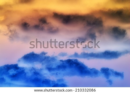 A dramatic abstract of orange and blue clouds.   A great texture image for a background or overlay.