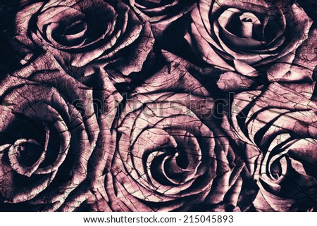 A close up of a bouquet of faded roses.  Image has been treated with a wood grain grunge layer and filtered for an vintage retro look.