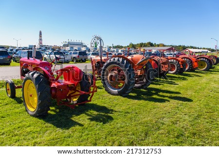 BRACEBRIDGE, CANADA - September 14, 2013: A row of vintage tractors at the 146th annual Bracebridge Fall Fair and Horse Show.