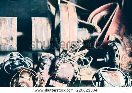 A group of old rusty electrical motors on a workbench in a workshop.  Filtered for a retro, vintage look.