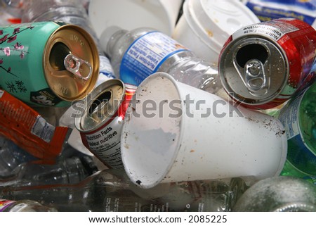 A pile of recyclable cans, cups and bottles in a recycle bin ready to be sorted and crushed.
