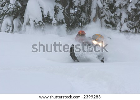 A skilled snow machine rider gets weightless while flying through deep powder snow.