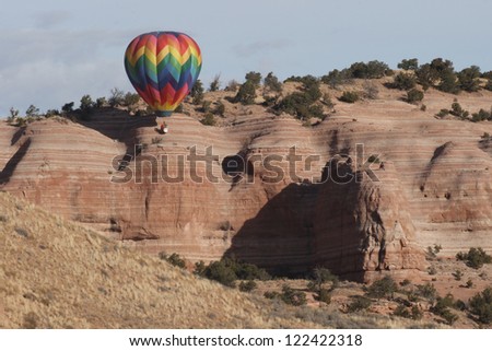 A single hot air balloon works its way along the steep cliffs in Red Rock State Park, near Gallup, New Mexico