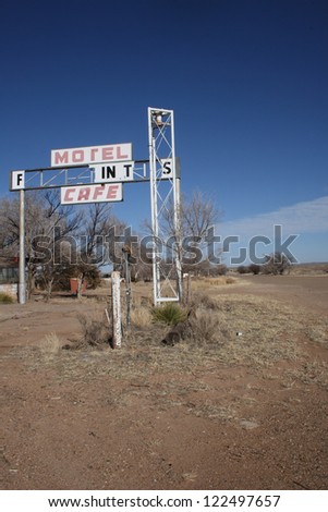 Old sign in front of an abandoned motel on Old US Route 66 near the Texas-New Mexico line, vertical orientation