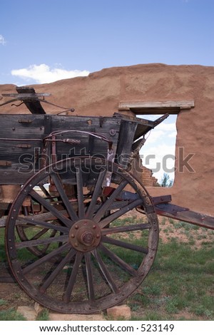 Front wheels of an old, restored conestoga style wagon on the grounds of old Fort Union, north of Santa Fe, New Mexico - vertical orientation.