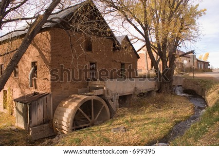 Old adobe grist grinding mill with waterwheel in La Cueva, New Mexico.