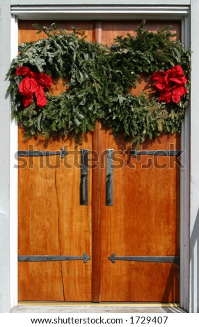 Two Christmas Wreaths on Wooden Doors