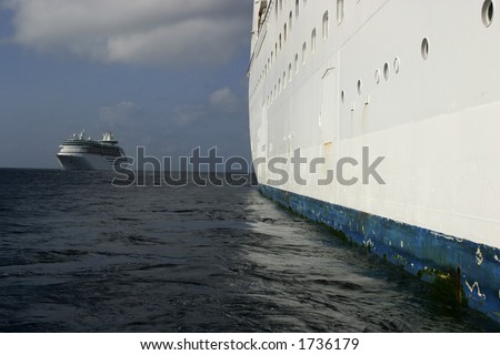 Side of Cruise Ship from Water Line with Second Ship on Horizon