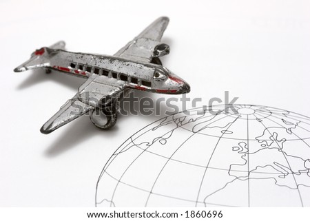 Toy Airplane on line drawing of the world (partial view).  Shallow depth of field from use of macro lens.