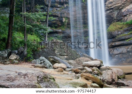Lower section of waterfall, with rocks and trees in the foreground.