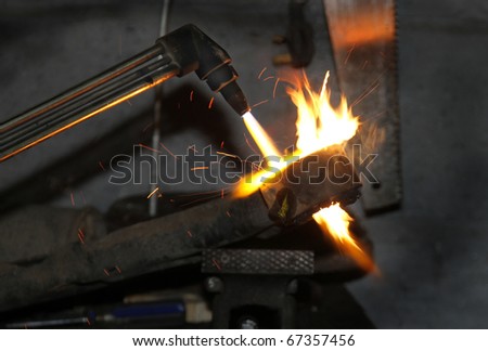 Oxygen Acetylene burning gun being used to heat up motor component before fitting.