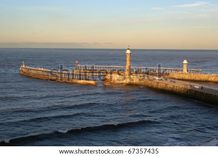 The twin jetties guarding Whitby harbour at the mouth of the river Esk.