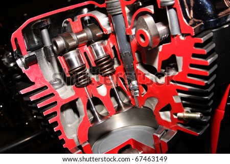 Valve and piston arrangement in cut away in high technology modern motor cycle engine.