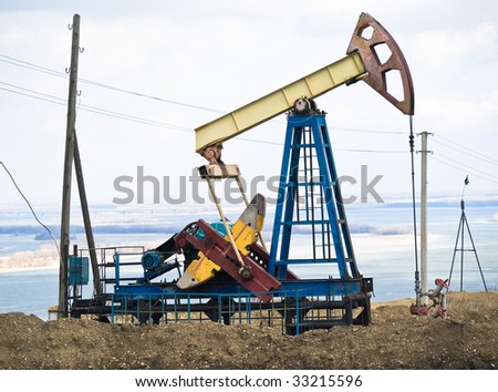 Oil pump on the river coast