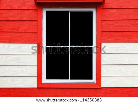 window on red and white wall