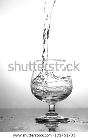 Water splashing in a glass, isolated on white