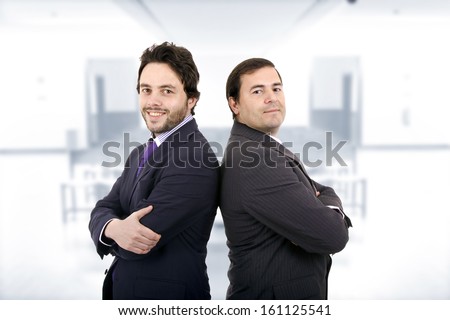 Two Businessman posing back to back together