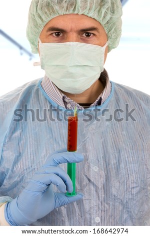 young male doctor with mask holding syringe