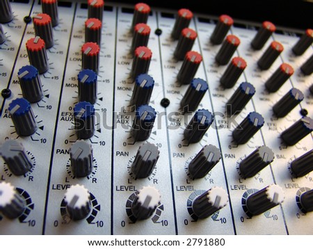 closeup of an audio mixer console in a recording studio