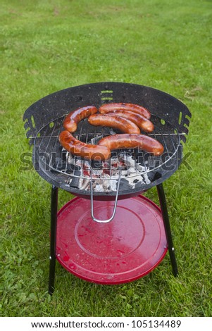 Sausage grilling on a charcoal grill in the garden