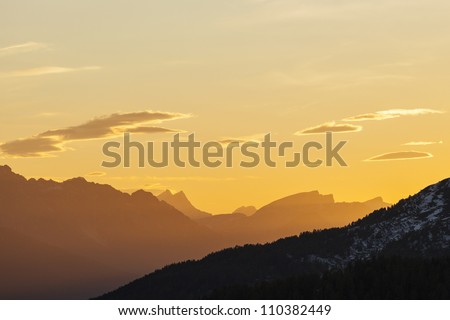 Mountains silhouette at sunset in the alps
