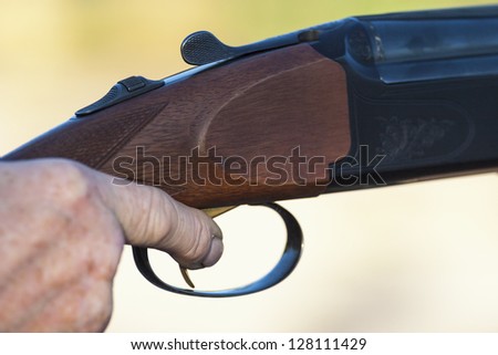 Finger on the trigger of a shotgun