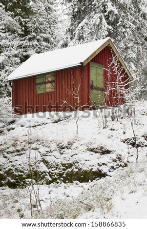 Red cabin in winter woods