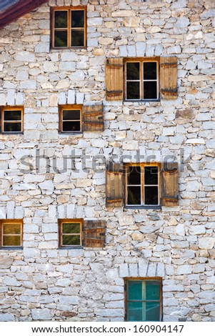 Old stone house with window shutters