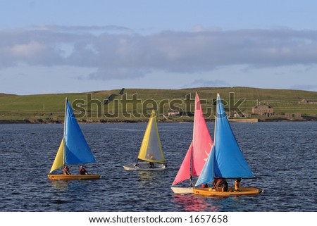Children practise with the small sailboats.
