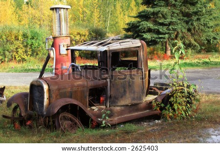 stock photo : Old rusty car at petrol station.