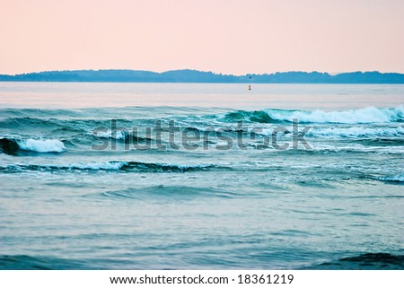 Waves come in to the beach in a beautiful eavning light