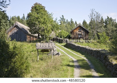 Old farm with stone walls around the winding road