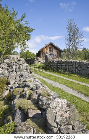 Old farm with stone walls around the winding road