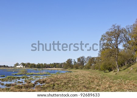 Castle by the lake in the rural landscape