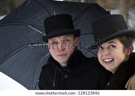 Tired man and happy woman under common umbrella