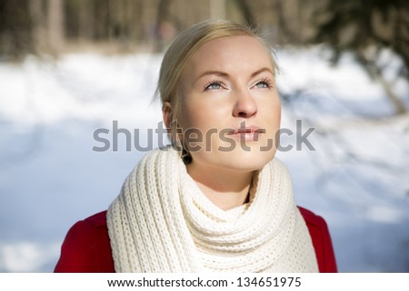 Zoomed woman warming face under sunlight at winter