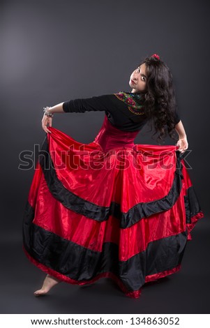 Young woman in spanish traditional clothes in studio