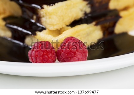 Zoomed berries with wafers poured over by chocolate