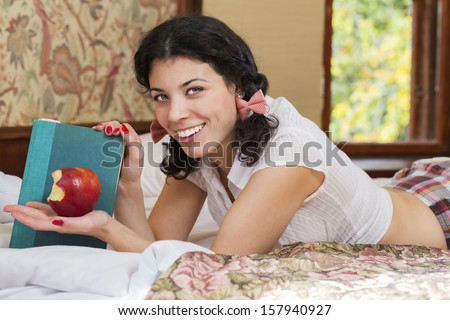 Woman show half bitten apple and brightly smile