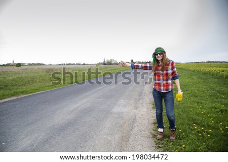 Young woman vote on empty road with flowers