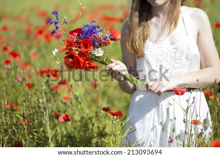 Young woman at white dress with zoomed bouquet