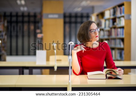 Young woman with glasses in library looking left