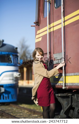 Woman in coat and wagon at sunny day