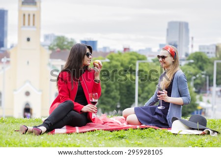 Two female friends on a picnic blanket