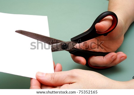 women hand is cutting paper with scissors