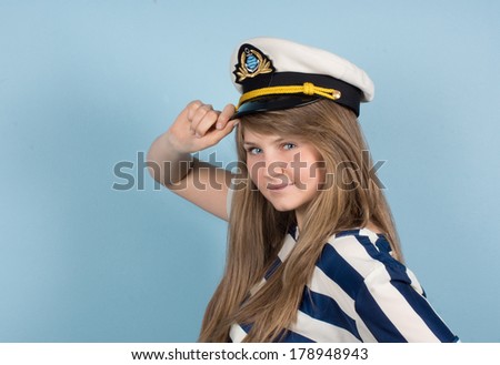 Pretty woman wearing sea Captain\'s cap and sailor shirt