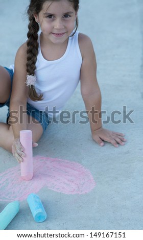 Little Girl Drawing on the sidewalk
